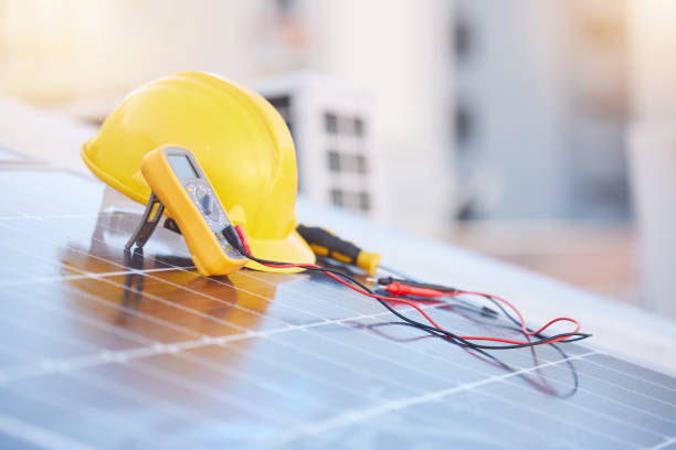 istock Tools, solar panels or helmet on roof for solar energy installation in a city development project. Voltmeter, Construction, renewable energy or electric engineering equipment for building maintenance 1470745376