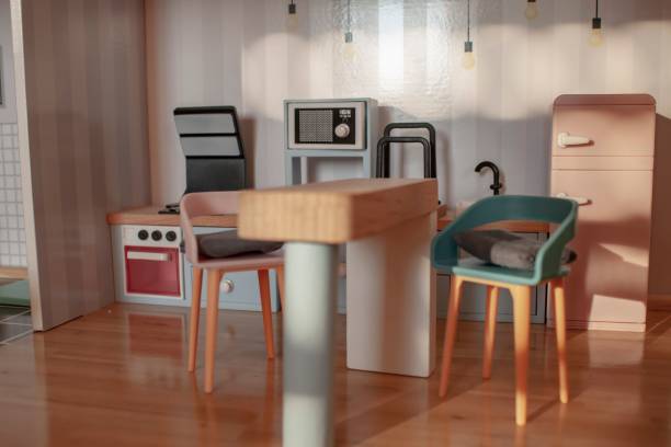 Toy kitchen set, complete with a table, blue chair and microwave
