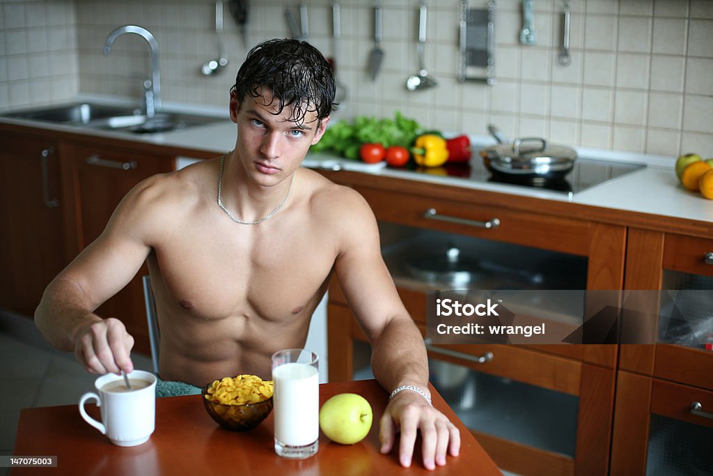 Sexy Man at the Kitchen Young muscular sexy man eating his breakfast at the kitchen Adult Stock Photo