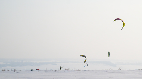 man is snowkiting in the field.