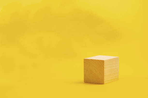 istock wooden podium cube on bright yellow background 1470753414