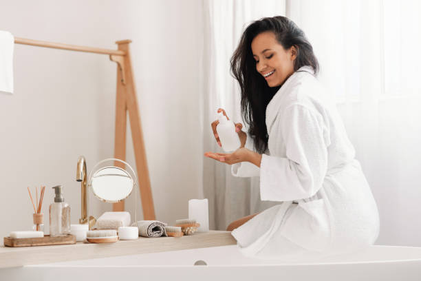 istock Female Caring For Body Holding Moisturizer Bottle In Modern Bathroom 1470753856