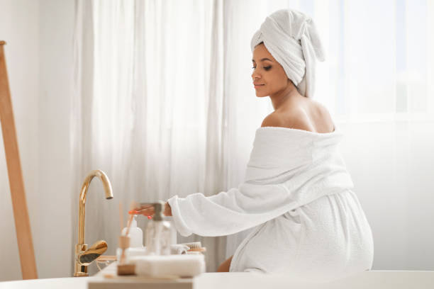 istock Relaxed Woman Enjoying Bodycare Rituals Using Cosmetics Sitting In Bathroom 1470754792