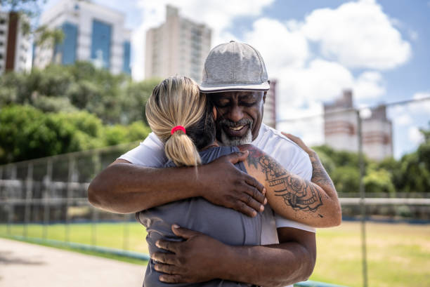 istock Senior man greeting a friend in the park 1470754890