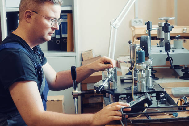 professional calibration of pressure gauges and sensors. working person sits at desk and is engaged in verification of instrumentation. - pressure gauge audio imagens e fotografias de stock