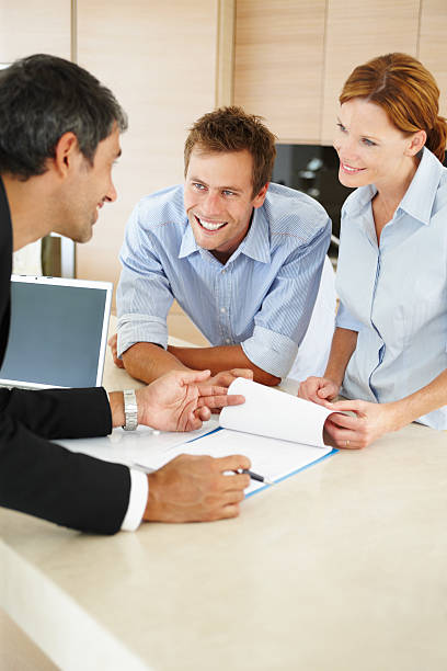 istock Consultant discussing with a young couple 147075701