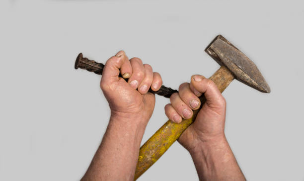 istock Old Sledge Hammer and tip Chisel in overworked male hands 1470757224