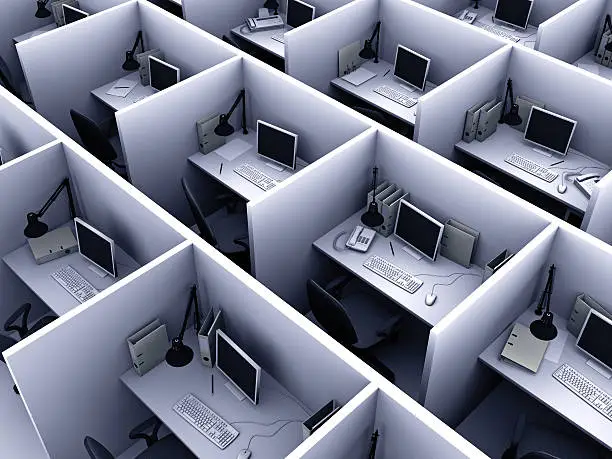 Photo of Aerial view of identical cubicles with desktop computers