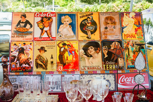 BENALMADENA, COSTA DEL SOL, PROVINCE OF MALAGA, SPAIN - September 14, 2016: Collection of vintage advertising tin signs at the flea market.