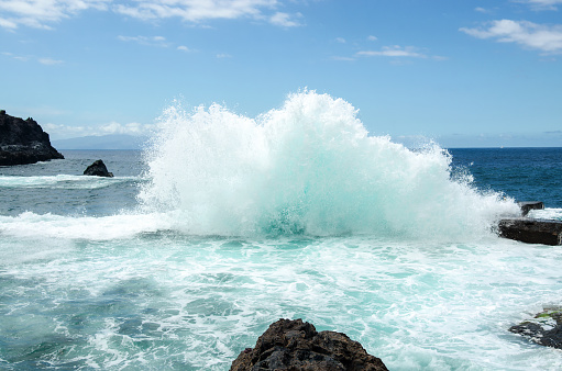 Big breaking wave. Natural tidal pool in Los Gigantes town, Tenetife, Canary Islands, Spain.