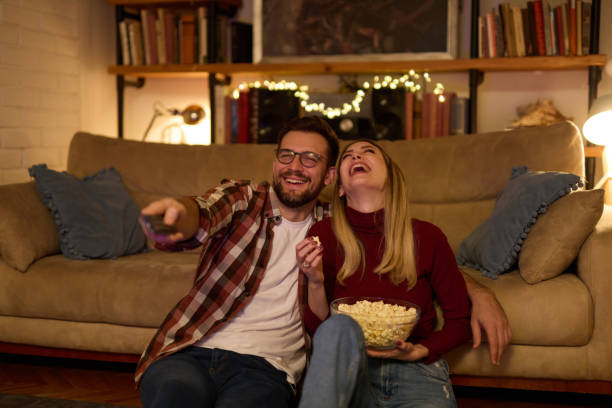 istock Young romantic couple watching TV at home 1470763010