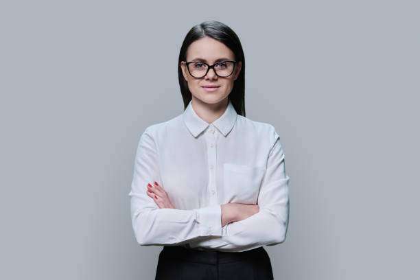 istock Confident business young female looking at camera on grey background 1470763298