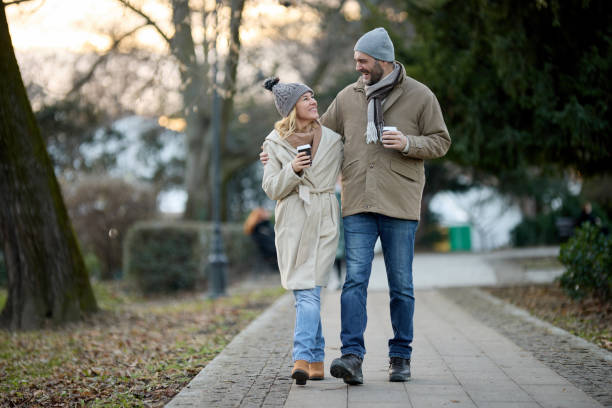 istock A happy romantic couple with coffee walking in the park 1470764885