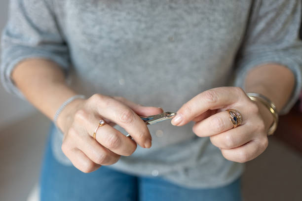 istock Senior woman's hands while manicuring with small metal pliers 1470765124