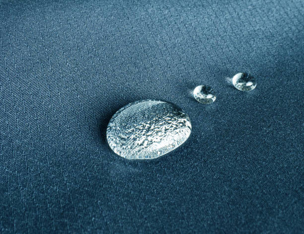 Three drops on technological waterproof and breathable fabric close-up