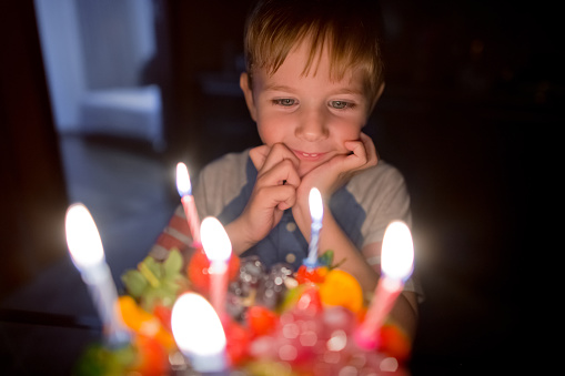 Child blowing birthday candles