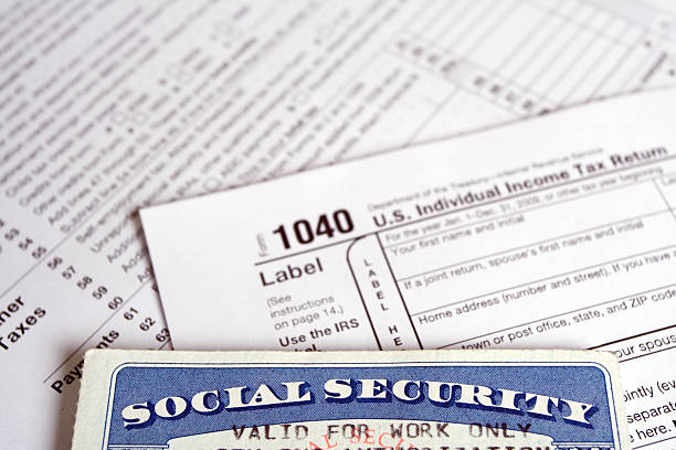 Social Security card with tax forms stock photo