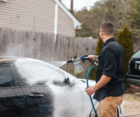 Auto Detailing - Man Washing Car with Pressure Washer Foam
