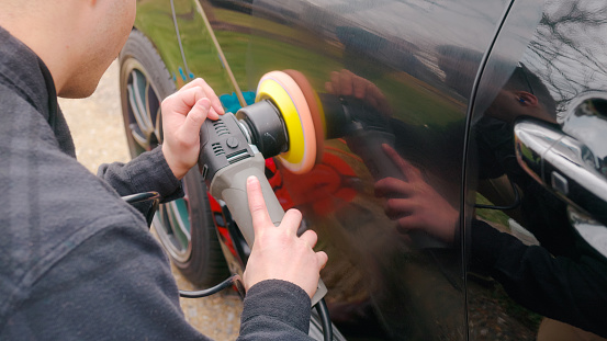 Paint Correction - Polishing Black Car Paint with Dual Action Polisher using Polishing Compound - Close Up