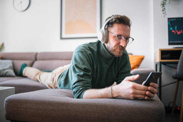istock Relaxing with audio book at home. 1470769825