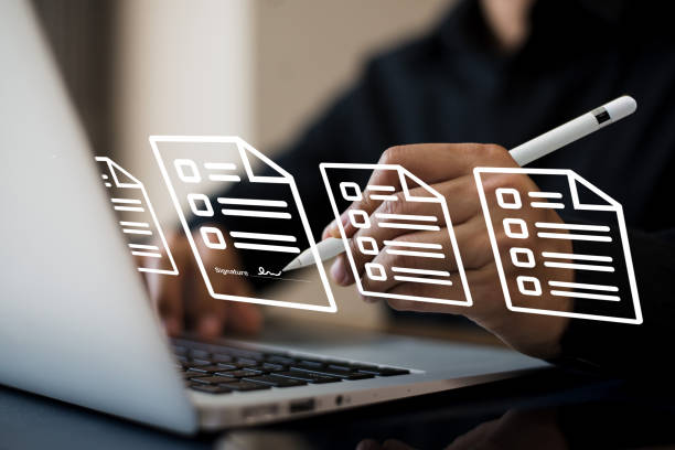 istock Young businessman signing an electronic document. He read the document and checked it before signing it for approval. 1470771026