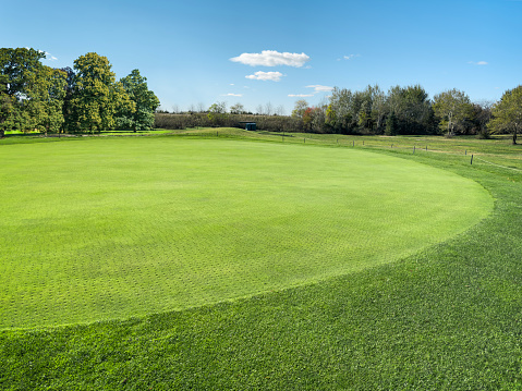 Wide angle grass golf course on a sunny day