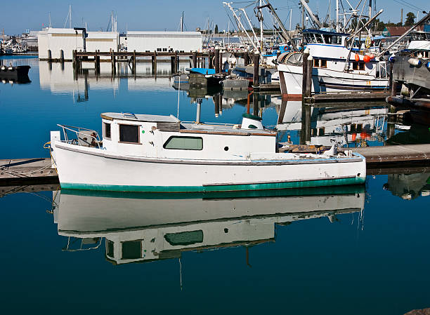 istock White Boat with Green Trim on Blue Water 147077305