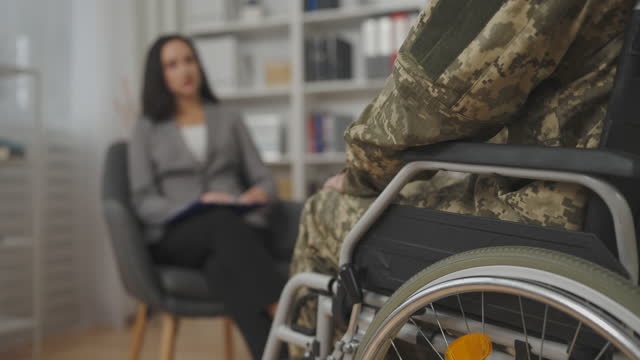 Closeup of military man with disability visiting psychiatrist, mental health