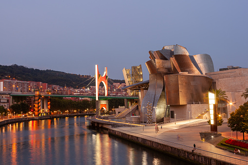 Bilbao, Spain - August 02, 2022: Sunset view of modern and contemporary art Guggenheim Museum and La Salve bridge