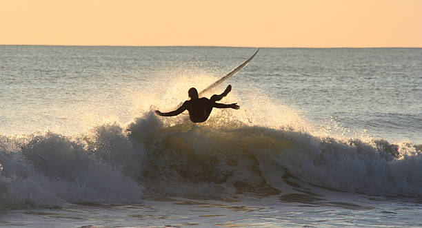 sunset surfer losing balance