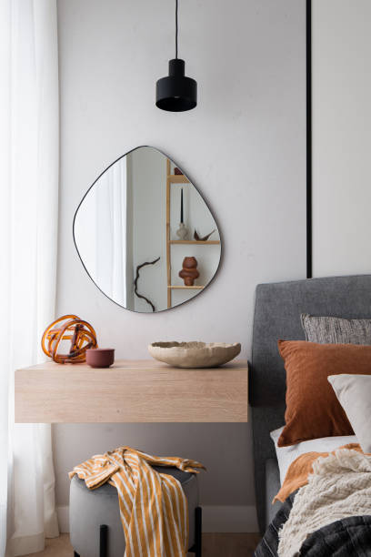 Modern mirror above dressing table in bedroom stock photo