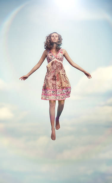 Young woman flying up stock photo