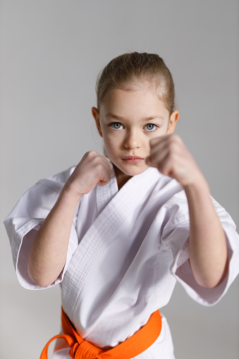Girl child doing karate block.