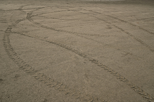 Used vehicles on the beach sand