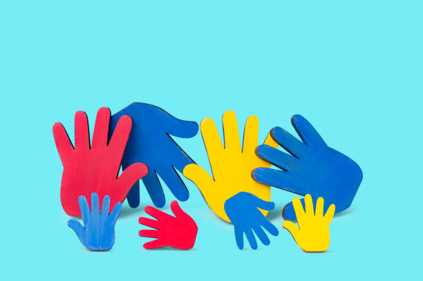 istock Colorfull puzzles hands on blue background. World Autism Awareness Day Concept 1470781667