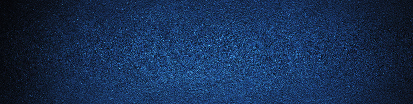 Black navy blue texture background with space for design. Dark rough concrete wall surface. Close-up. Web banner. Wide. Panoramic.