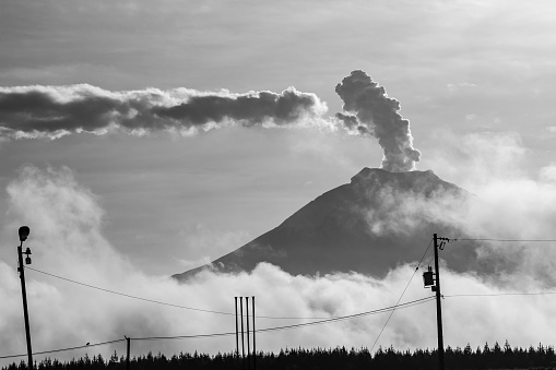 Cotopaxi in eruption, an immense column of steam rises a few thousand meters above the volcano.