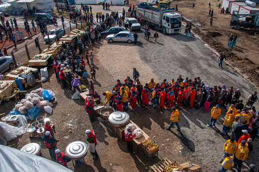Van, Turkey - October 28, 2011: Van Earthquake 7.2 / Earthquake survivors and volunteers during the meal