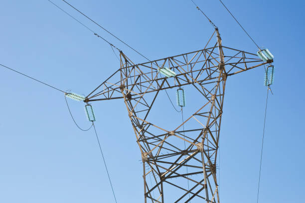 istock Power tower and transmission lines on blue background 1470791476