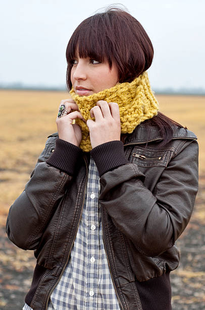istock Young Woman Adjusting Chunky Scarf 147079230