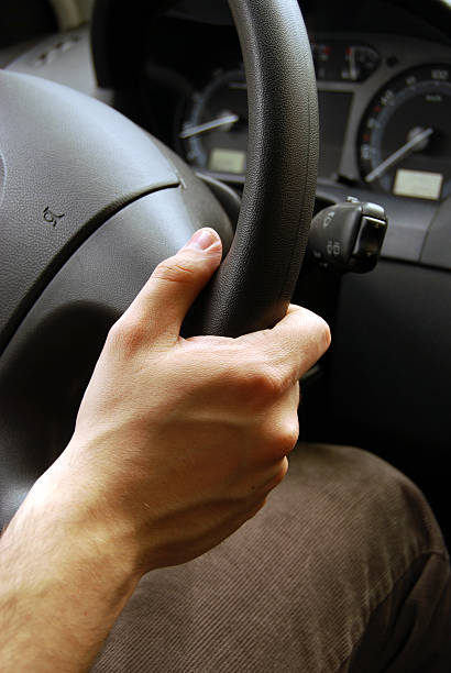 istock Close up of mans hand on a steering wheel 147079293