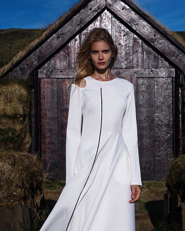 Young girl in an ancient settlement of the peoples of Iceland. Fairytale Fashion Story