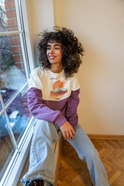 istock Modern Caucasian woman looking through window 1470794951