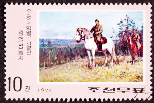 North Korean postage stamp showing Kim Il Song riding a horse.  Part of a series of stamps about his role during the war against Japan - See lightbox for more