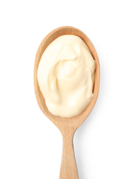 istock Mayonnaise in wooden spoon isolated on white, top view 1470797184