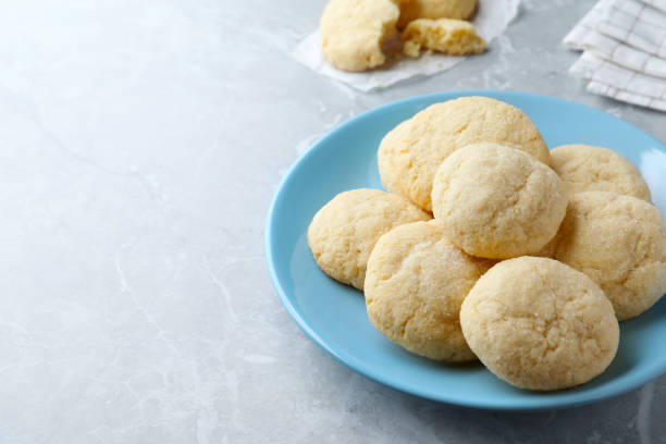 istock Delicious sugar cookies on light grey marble table, space for text 1470797347
