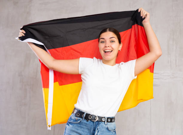 istock Smiling young woman holding Germany flag 1470797672