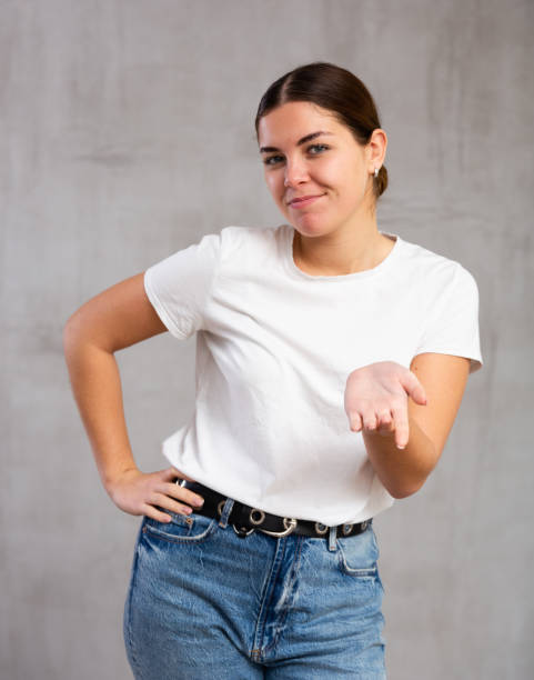 istock Smiling young woman in casual clothes gesturing 1470797712