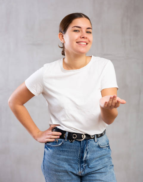 istock Smiling young woman in casual clothes gesturing 1470797714