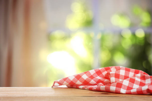 istock Red and white checkered tablecloth on wooden table indoors, space for design. Bokeh effect 1470797719